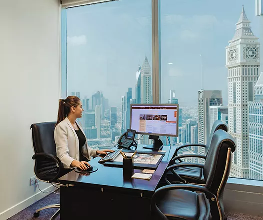 Prestigious serviced offices in Emirates Towers, Dubai were a women is finishing her work.