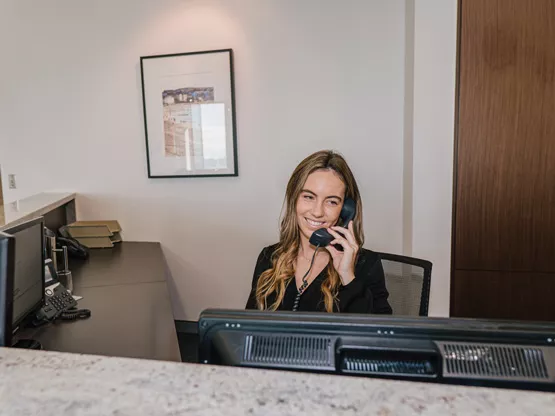Servcorp receptionist answering calls—professional call handling included with every virtual office package.