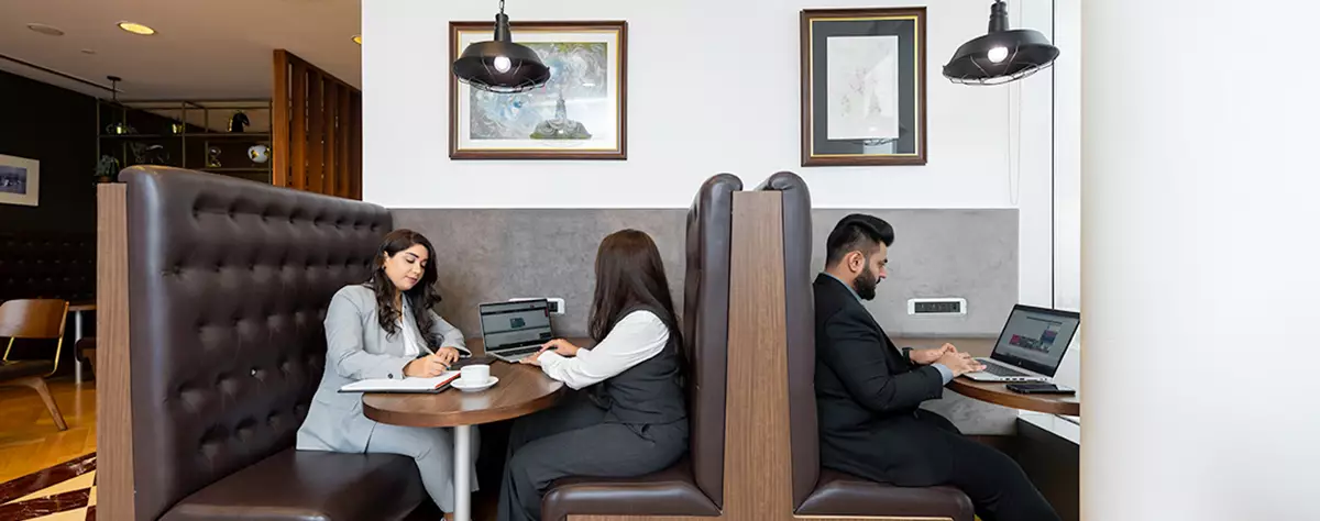  Modern coworking space at Boulevard Plaza, Dubai with clients working in a proffesional environemnt .