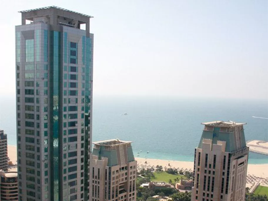  Al Habtoor Business Tower in Dubai Marina, rising elegantly near the coastline with panoramic views of the Arabian Gulf and surrounding high-rises.